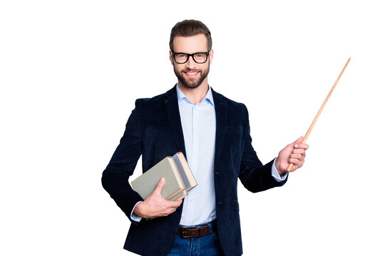 Portrait of cheerful teacher with stubble in shirt jacket, having books in hand and showing with pointer on empty place, copy space, looking at camera, isolated on grey background