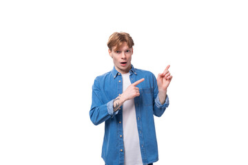 young well-groomed caucasian red-haired man in a denim shirt actively gesticulates