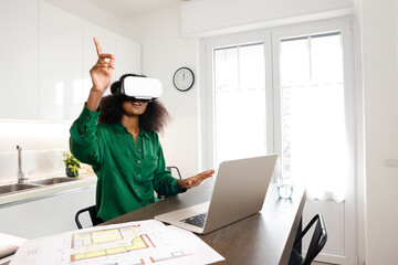 An African American woman architect working at home and introduces her virtual reality home...