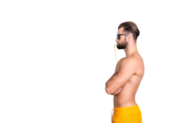 Portrait with copy space, empty place of fit sportive lifeguard with stubble, hairstyle, crossed hands, holding whistle with lips  isolated over grey background