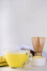 Yellow matcha drink. Mango matcha extract tea or latte, fruity healthy beverage on white background copy space