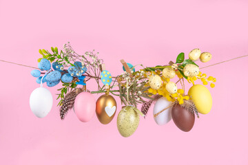 Creative bright spring Easter holiday concept. Painted Easter eggs, spring flowers, leaves and...