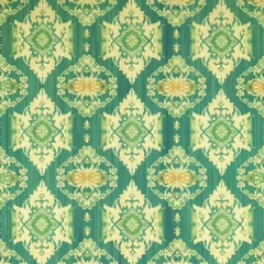 Foto op Canvas A green and yellow patterned carpet with a floral design. The carpet is made of a soft material and has a unique, intricate design © siriwan