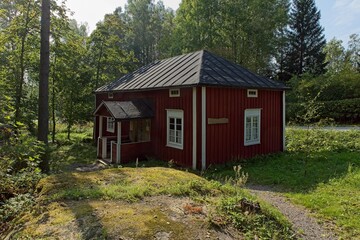 Fototapeta na wymiar Old traditional style red wooden house in summer, Finland.