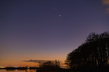 Jupiter and Saturn planets in the night sky appearing as a rare phenomenon at dusk during winter....