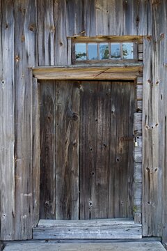 Old weathered barn door on a traditional barn, Finland.