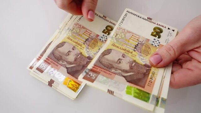 Woman hands counting money 50 lev Bulgarian in paper banknotes bills in office. Stack of hundred lev bills. Banknotes in hands close-up. Bulgarian economy Eurozone. Currency exchange. Cash payment