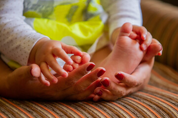New born baby feet on the hands of a happy dad 