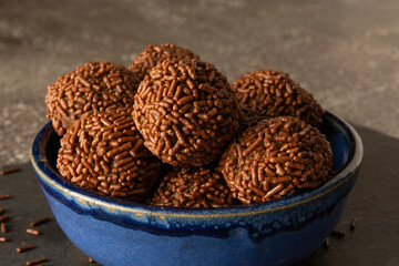 Brigadeiro brazilian chocolate balls party candy with chocolate flakes front view dark background