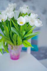 delicate bouquet of white tulips in a vase in the room