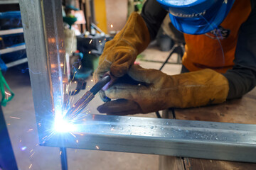 Galvanized metal after being welded with a welding machine caused a spark. Welder wearing...