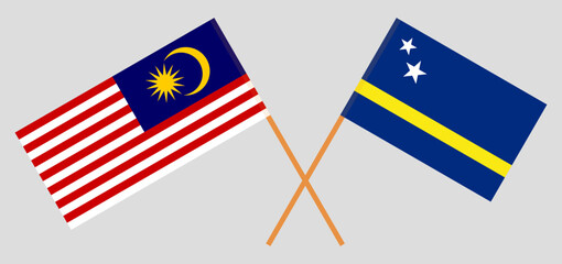 Crossed flags of Malaysia and Country of Curacao. Official colors. Correct proportion