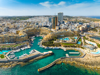 Aerial view of St. Julian's city and modern high buildings. Day. Malta island