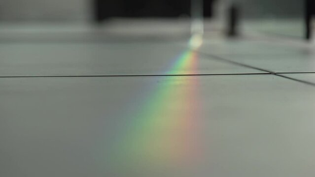 sun light breaking in prisma colors on floor