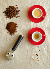 cup of freshly brewed espresso coffee with portafilter,coffee beans and ground coffee,flat lay,free...