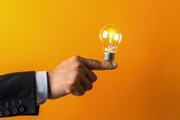 Businessman holding a light bulb, concept of business, idea and innovation. - obrazy, fototapety, plakaty