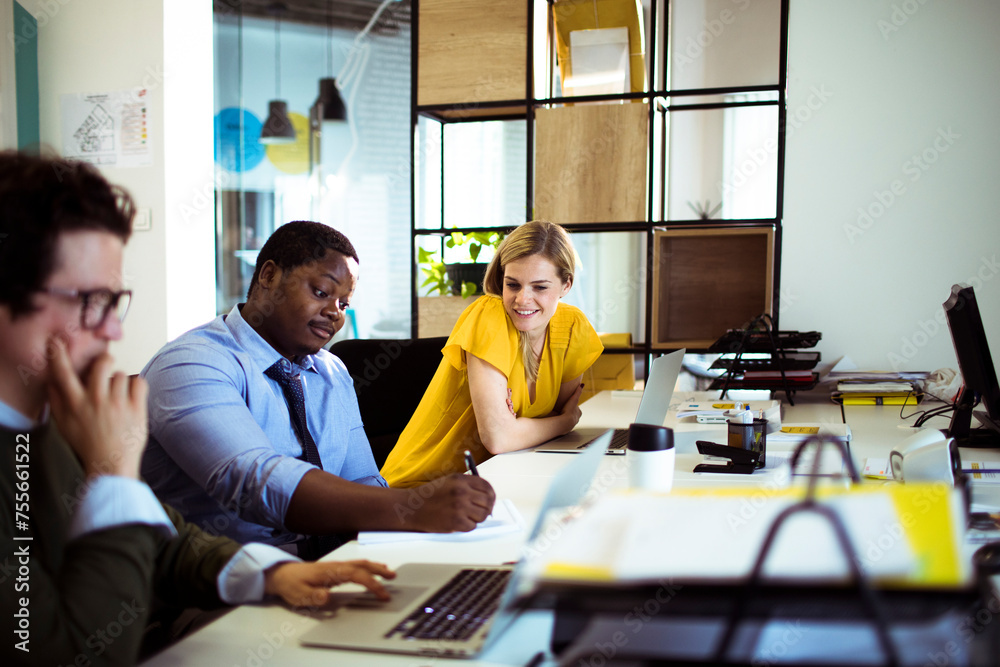 Wall mural diverse young colleagues talking in modern office