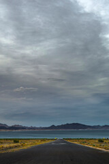 Desert Sunset Serenity: 4K Ultra HD Image of Road to Lakeshore with Clouds at Sunset