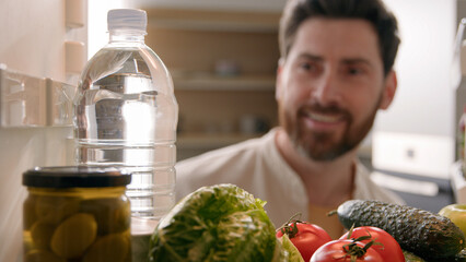 Point of view POV inside refrigerator Caucasian man male thirsty guy open fridge full of products...