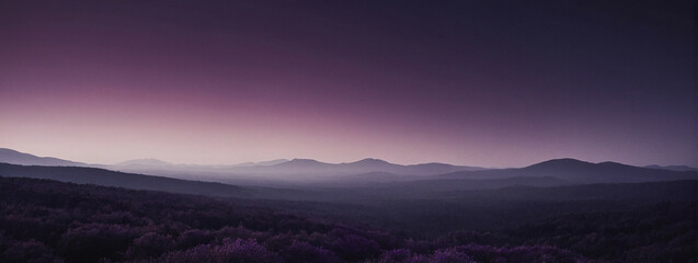 Fototapeta premium Purple Sunset Over a Serene Mountain Range