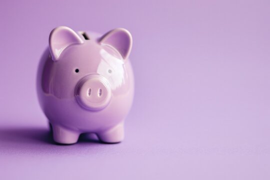 Lilac piggy bank, savings and finance concept, lilac background.