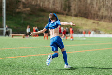 Young soccer player celebrating on the field