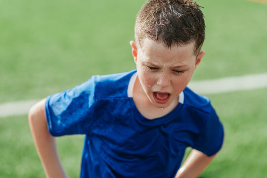 Young boy showing determination on sports field