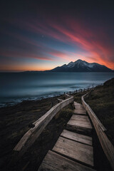 Wooden Path Leading to Mountain With Sunset Background
