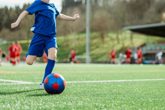 Youth soccer player in action on field
