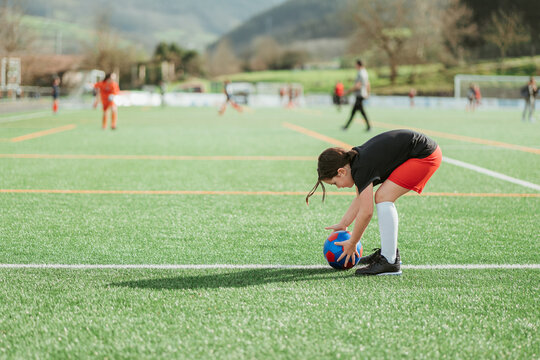 Young athlete stretching before a soccer match - Powered by Adobe