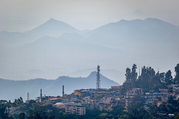 A serene morning landscape showing the lush hills and architecture of Kodaikanal.