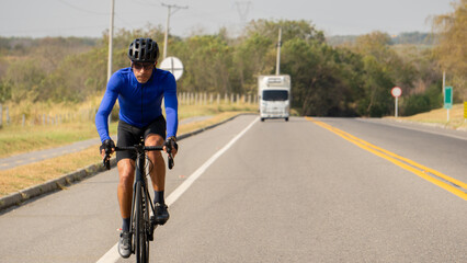 Obraz premium Man riding bicycle on a road outdoors