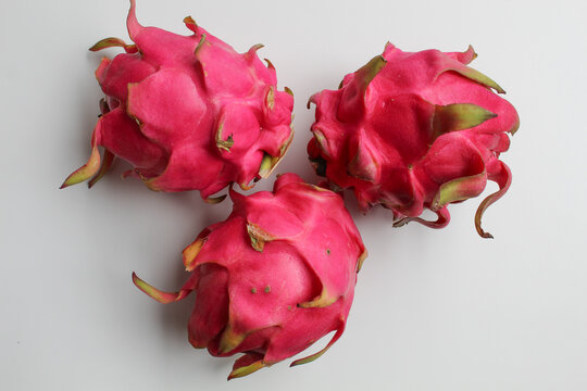 Red pitaya fruits. Three fresh dragon fruit, isolated on white background