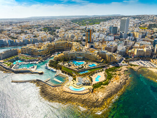 Landscape of f St. Julian's city, high buildings. Day. Maltese island, Mediterranean sea - obrazy, fototapety, plakaty
