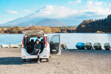 Woman tourist enjoy with Fuji Mountain at Lake Shoji, happy Traveler sightseeing Mount Fuji and...