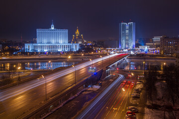Fototapeta na wymiar Government of Russian Federation, Novoarbatsky bridge at night in Moscow, this photo on billboard