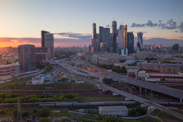 Naklejka na ściany i meble Third transport ring, railway and skyscrapers at evening during sunset in Moscow, Russia