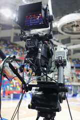 Professional modern camera at basketball game in stadium, shallow dof
