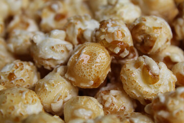 Background texture of caramel popcorn. Popcorns coated by melted sugar