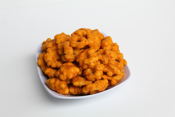 Sakura ribut, fried dough with flower shape, savory taste. Snack from Indonesia. Isolated on white background
