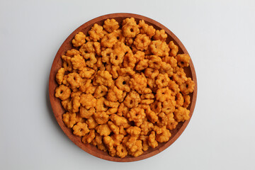 Sakura ribut, fried dough with flower shape, savory taste. Snack from Indonesia. On wooden plate, isolated on white background, flat lay or top view