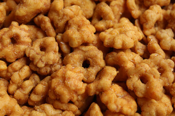 Background texture of Sakura Ribut, fried dough with flower shape, coated with seasoning powder. Snack from Indonesia