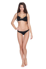 Fototapeta premium Beautiful girl in black underwear poses isolated on white background