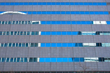 ビルの窓に映るビルと青空