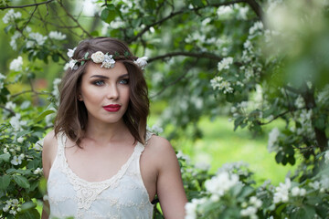 Beautiful healthy woman with fresh skin, make-up and brown wavy hair outdoor