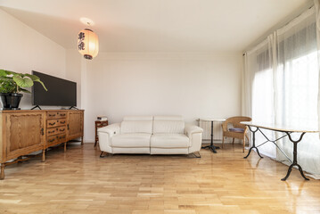 Apartment with kitchen with brown furniture, white countertop, stools with chrome legs,