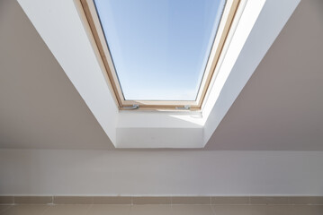 Wooden frame skylight with metal meshes of an attic room