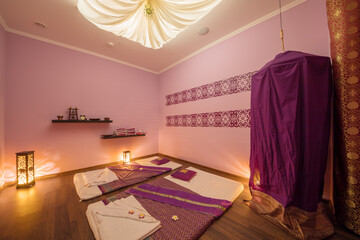 Empty beautiful cozy room with mats for thai massage and curtain dressing