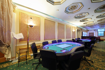 Casino with modern electronic poker table and screens on wall, my photo on screens