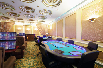 Empty casino with modern electronic poker table and screens on wall, my photo on screens
